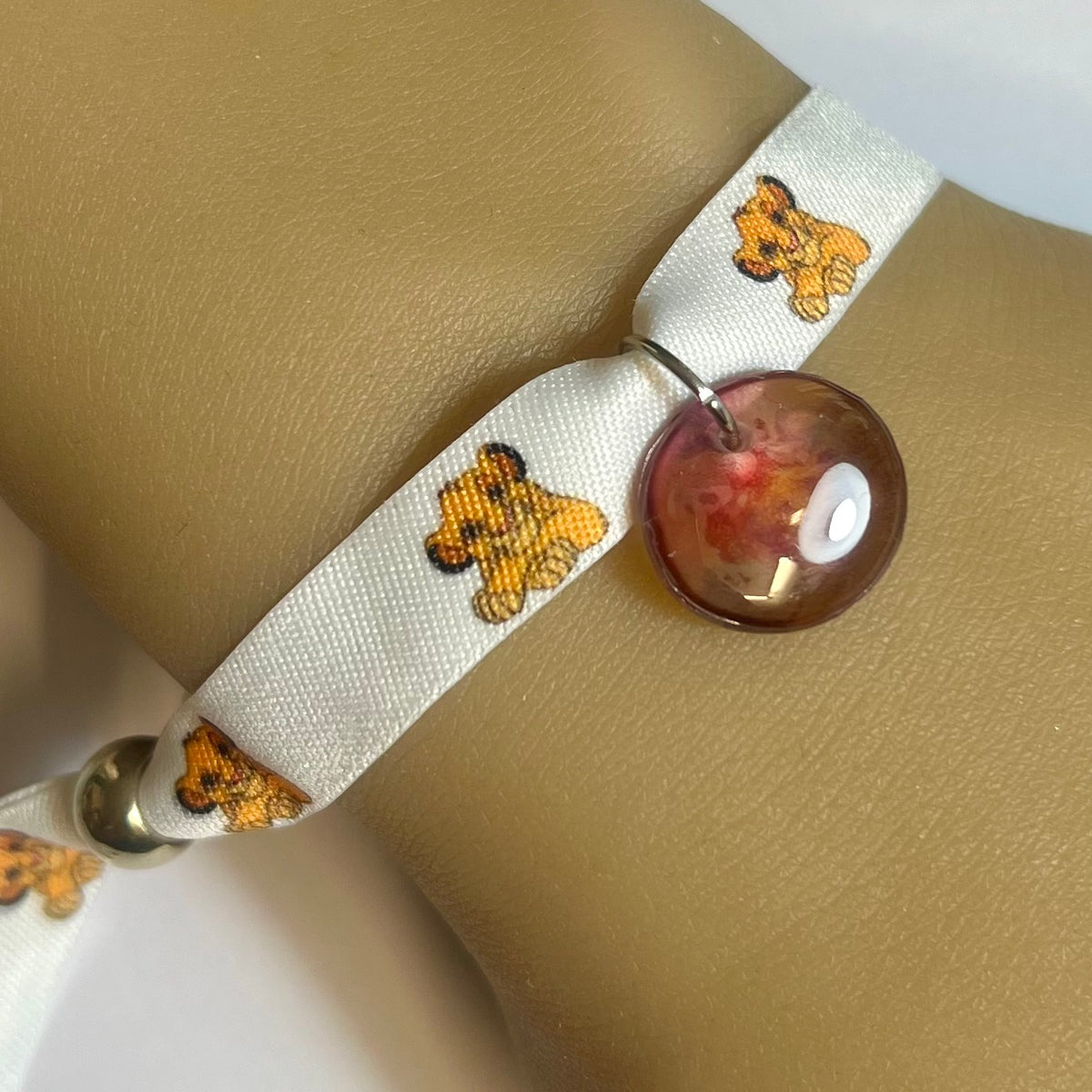 Bracelet en tissu blanc imprimé Simba avec charm assorti et fermeture réglable – Kokoha
